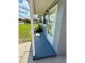 Side view of a light gray home showing the entryway and part of the front lawn at 2655 Hempstead Dr, Lakeland, FL 33801
