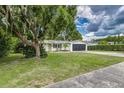 Charming single-story home with a well-maintained lawn, freshly painted exterior, and a two car garage at 2726 Cleveland Heights Blvd, Lakeland, FL 33803