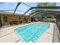 Inviting screened-in pool area perfect for outdoor entertaining, including ample seating and dining space at 3315 Cross Fox Dr, Mulberry, FL 33860