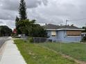 Cozy single-Gathering home with fenced yard and easy access to the sidewalk at 337 Pearl St, Lake Wales, FL 33853