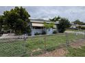 View of home showcasing fenced yard and manicured landscaping at 337 Pearl St, Lake Wales, FL 33853