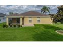 Spacious backyard features a well-maintained lawn, a screened patio, and an American flag at 3427 Waterlute Way, Lakeland, FL 33811