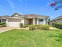 Well-maintained single-story home with manicured lawn and walkway at 3806 Osprey Pointe Cir, Winter Haven, FL 33884