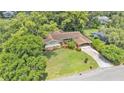 An aerial view of the property featuring a spacious lawn, mature landscaping and attached carport at 4219 Forest Hills Dr, Lakeland, FL 33813