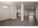 Open concept living space with kitchen, dining, and living areas with modern wood-look tile floors at 5409 Waterside Dr, Auburndale, FL 33823
