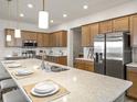 Modern kitchen with stainless steel appliances, large island, and ample counter space at 557 Silver Course Radl, Ocala, FL 34472