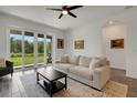 Bright living room featuring a sliding glass door and neutral decor at 6261 Great Bear Dr, Lakeland, FL 33805