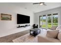 Modern living room with sleek furniture and a large screen television at 6261 Great Bear Dr, Lakeland, FL 33805