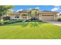 Beautiful home featuring mature landscaping, a well-manicured lawn and a two-car garage at 633 Hart Lake Dr, Winter Haven, FL 33884