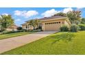 Charming home featuring mature landscaping, a long driveway, and a spacious two-car garage at 633 Hart Lake Dr, Winter Haven, FL 33884