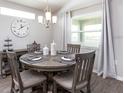 Cozy dining area with a round table, seating, and stylish chandelier fixture above at 7478 Sw 108Th St, Ocala, FL 34476