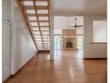 Spacious living room featuring a brick fireplace, hardwood floors, and staircase at 929 Hammock Shade Dr, Lakeland, FL 33809