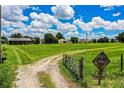 Scenic view of a large, grassy property with a dead end sign and a gated entrance at 10 Webb Rd, Winter Haven, FL 33881