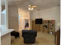 Cozy living area featuring neutral carpet, vaulted ceilings and a seamless flow into the kitchen at 1011 Tequesta Trl, Lake Wales, FL 33898