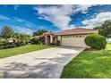A well-maintained lawn, tile roof, and convenient two-car garage add to this home's appeal at 104 Morning Glory Cir, Winter Haven, FL 33884