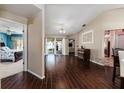 Inviting living room with dark wood-look floors and a glimpse of the screened patio at 104 Morning Glory Cir, Winter Haven, FL 33884