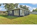 Well-kept home with a fresh exterior, complemented by a lush green lawn and manicured landscaping at 1050 Reynolds Rd, Lakeland, FL 33801