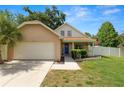 Charming single-Gathering home with a well-manicured lawn, white picket fence and attached two car garage at 114 Ed Padgett Rd, Lakeland, FL 33809