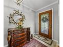 Foyer featuring a decorative mirror above a wooden dresser and a decorative glass front door at 1308 Timberidge N Loop, Lakeland, FL 33809