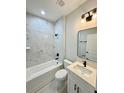 Stylish bathroom featuring marble wall tile, a sleek sink, and black hardware at 1683 Sw 3Rd St, Ocala, FL 34471