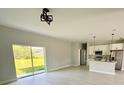 Bright, open-concept living space with sliding glass doors and a modern kitchen at 1683 Sw 3Rd St, Ocala, FL 34471