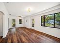Bright living room with wood floors, ceiling fan, and windows with views of the outdoors at 1830 Casco, Lakeland, FL 33801
