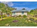 Charming home featuring freshly cut green grass and a well-maintained landscape at 200 Spurlock Rd, Frostproof, FL 33843
