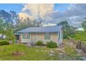 Charming home featuring freshly cut green grass and a well-maintained landscape at 200 Spurlock Rd, Frostproof, FL 33843