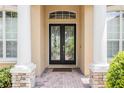 Close-up of the front entrance showcasing leaded glass double doors and decorative pillars at 2026 Indian Sky Cir, Lakeland, FL 33813