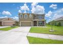 Charming two-story home with a well-manicured lawn, neutral exterior, and two-car garage at 2062 Blue Highlands Dr, Lakeland, FL 33811