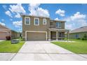 Charming two-story home with a well-manicured lawn, neutral exterior, and two-car garage at 2062 Blue Highlands Dr, Lakeland, FL 33811