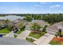 Aerial view of a lovely residential neighborhood with a serene lake and manicured lawns at 2544 Ladoga Dr, Lakeland, FL 33805