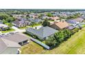 An aerial view of a single-story home with a fenced backyard and a private outdoor living space at 2817 High Winds Ln, Lakeland, FL 33813