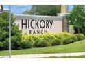 Hickory Ranch community sign with lush landscaping adding to the neighborhood's curb appeal at 312 Walnut Ln, Auburndale, FL 33823