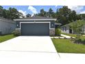 Charming single-story home with a well-maintained lawn and attached two car garage at 312 Walnut Ln, Auburndale, FL 33823