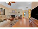 Bright living room featuring a cozy fireplace, wood floors, and ample natural light at 3783 Wildcat Run, Lakeland, FL 33810