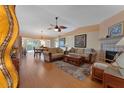 Open-concept living area with wood floors, comfortable seating, and a seamless transition to the dining area at 3783 Wildcat Run, Lakeland, FL 33810