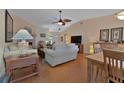 Spacious living room with wood flooring, ceiling fan, and a view into the dining area at 3783 Wildcat Run, Lakeland, FL 33810