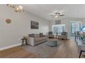Bright living room with hardwood floors, neutral paint, modern furniture, ceiling fan and natural light at 4309 Shipp Ct, Lakeland, FL 33813