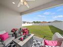 Covered patio with stylish furniture overlooking a spacious, fenced backyard at 4340 Reding Way, Lakeland, FL 33813