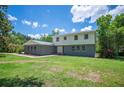 Charming home featuring a mix of brick and vinyl siding, complemented by a well-maintained lawn and mature trees at 4908 S Bedford Ln, Lakeland, FL 33813