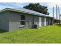 Rear exterior view of the duplex, showing the tidy lawn and two air conditioning units at 508 & 510 2Nd Sw St, Fort Meade, FL 33841