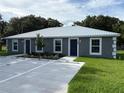 View of a two-unit residential building featuring a metal roof, reserved parking, and green lawn at 514 & 516 2Nd Sw St, Fort Meade, FL 33841