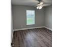 Bright bedroom featuring wood floors, ceiling fan and a sun-filled window at 520 & 522 2Nd Sw St, Fort Meade, FL 33841