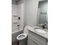 Bathroom with a shower and tub combination, and a granite countertop vanity at 526 & 528 2Nd Sw St, Fort Meade, FL 33841