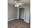 Bedroom with wood-look vinyl floors and a large closet with shelving at 526 & 528 2Nd Sw St, Fort Meade, FL 33841