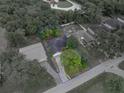 Aerial view of property showcasing the home's layout, surrounding trees, and lot boundaries at 5522 1St Se St, Lakeland, FL 33812