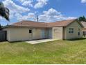 Expansive backyard featuring a well-maintained lawn and a small concrete patio at 624 Brockton Dr, Kissimmee, FL 34758