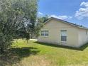 Lush green backyard with a mature tree providing shade and privacy to the property at 624 Brockton Dr, Kissimmee, FL 34758
