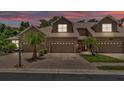 Inviting townhome showcasing a well-maintained brick driveway under a colorful sunset at 6365 Torrington Cir, Lakeland, FL 33811